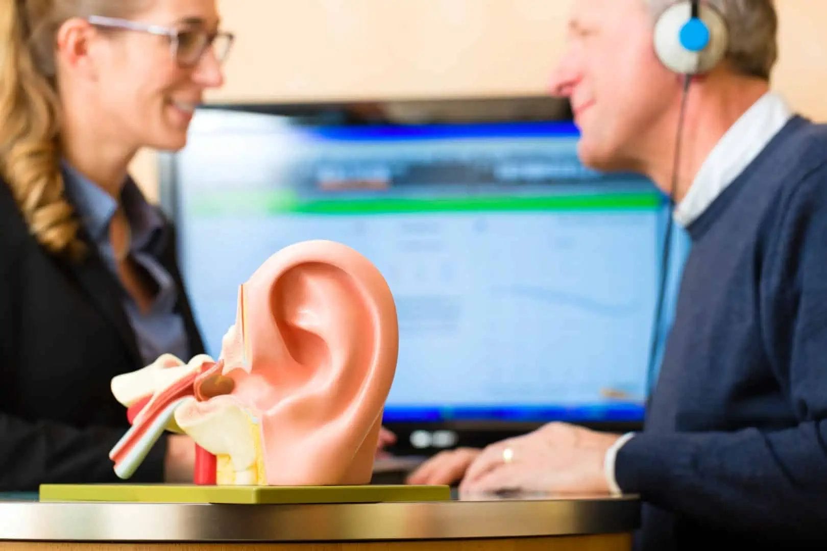 An Audiologist testing a patients hearing as part of hearing evaluation