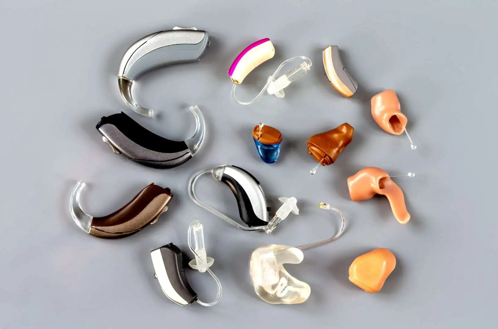 A photo of hearing aids arranged to show different styles of hearing aids.